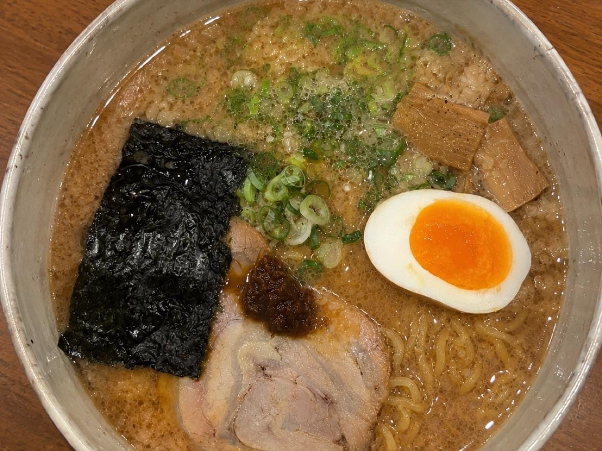 Tonkotsu shoyu ramen with chashu, soft-boiled egg, nori, scallions, and back fat