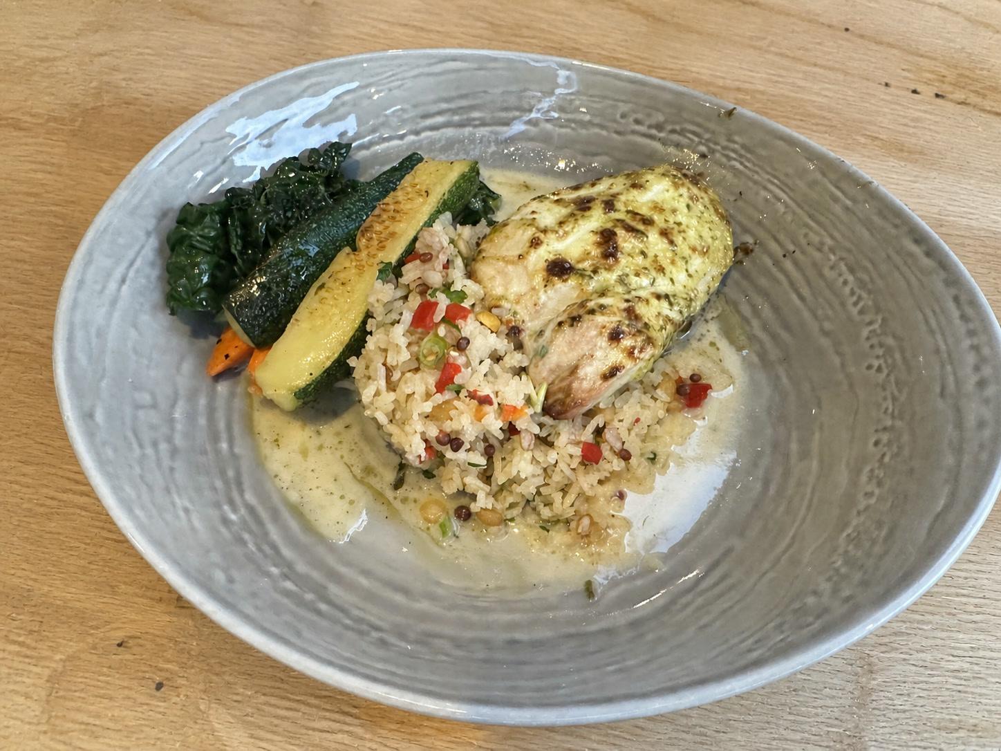 Baked white fish with browned basil lemon garlic glaze, herbed rice, zucchini, carrots, and greens