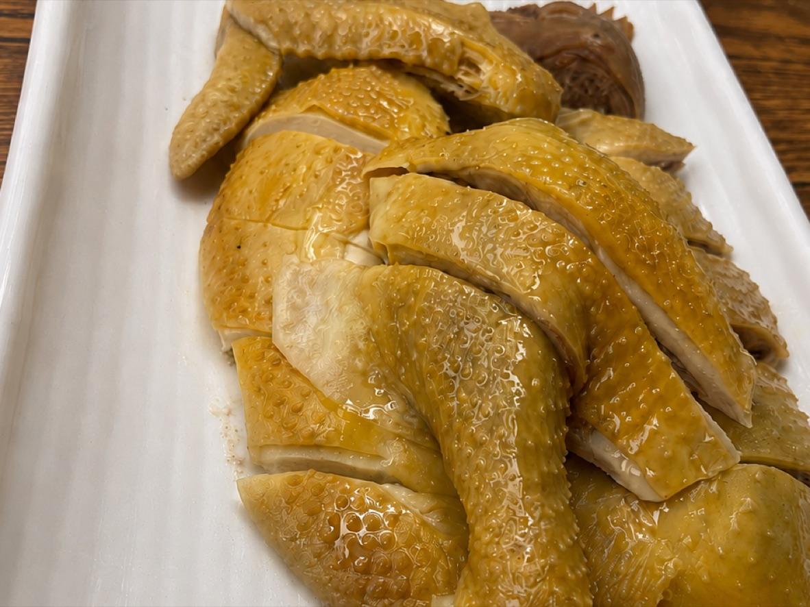 Sliced Cantonese white-cut chicken with golden skin and ginger-scallion sauce