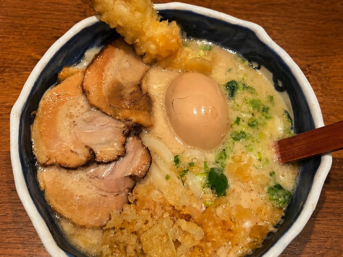 Creamy tonkotsu udon with sliced chashu, shrimp tempura, a soft egg, and scallions