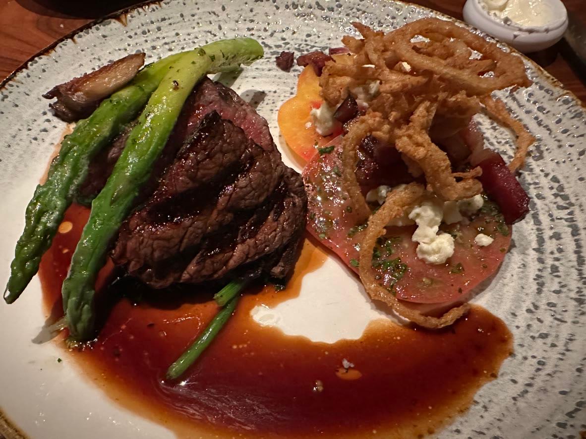 Grilled beef tenderloin with asparagus, braised short rib, tomato, blue cheese, crispy onions, and red wine sauce