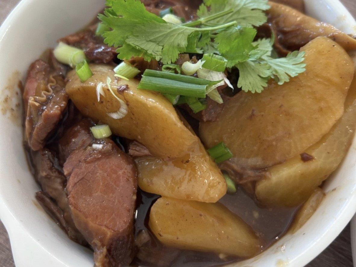 Braised beef brisket and daikon in dark chu hou sauce with cilantro