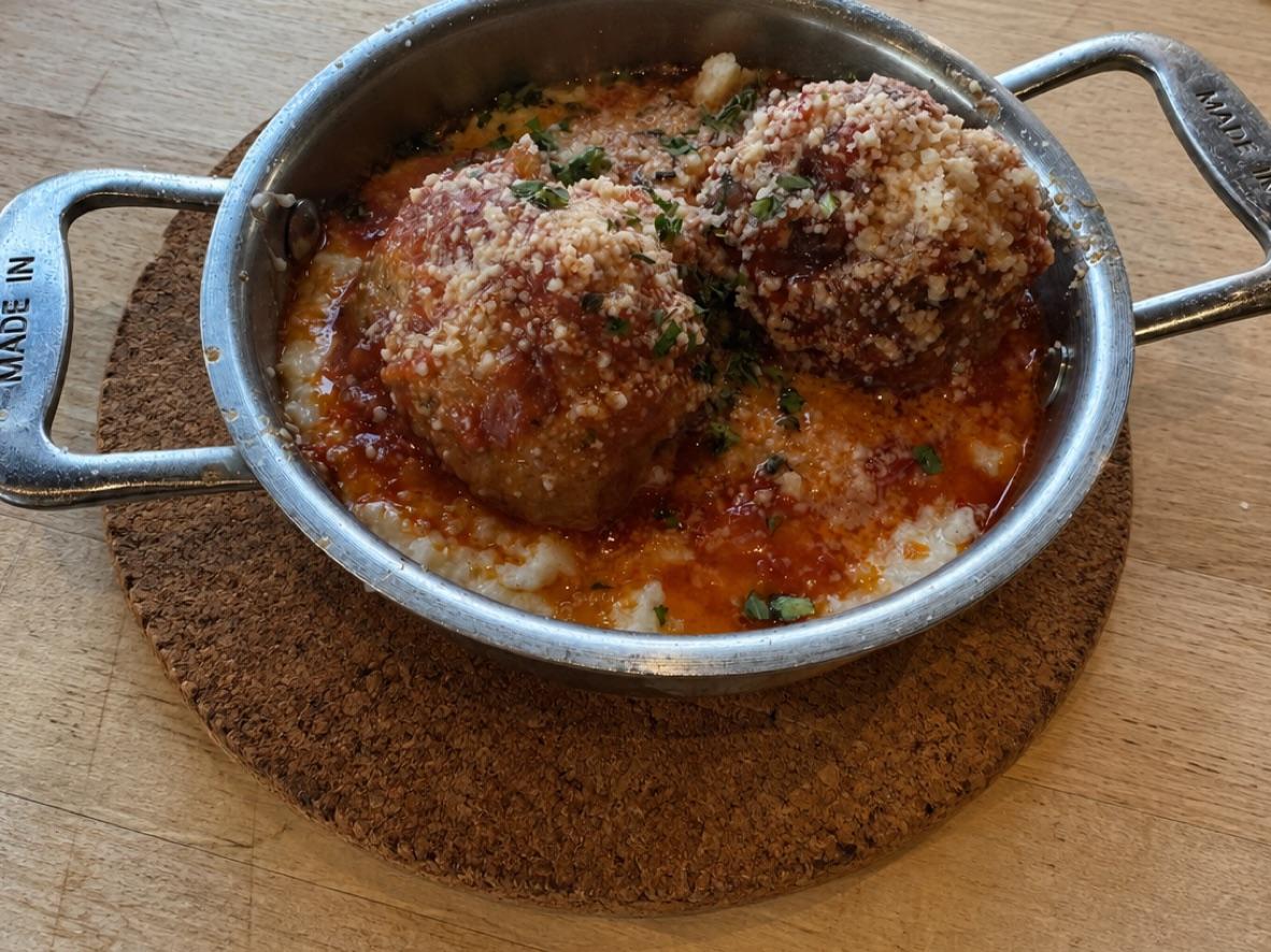 Italian meatballs in marinara over creamy polenta, topped with Parmesan