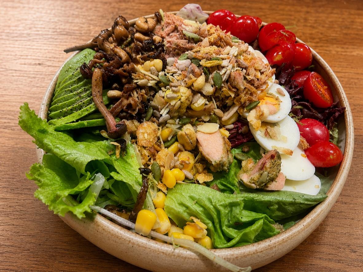 Loaded salad with chicken, tuna, avocado, eggs, corn, mushrooms, and tomatoes