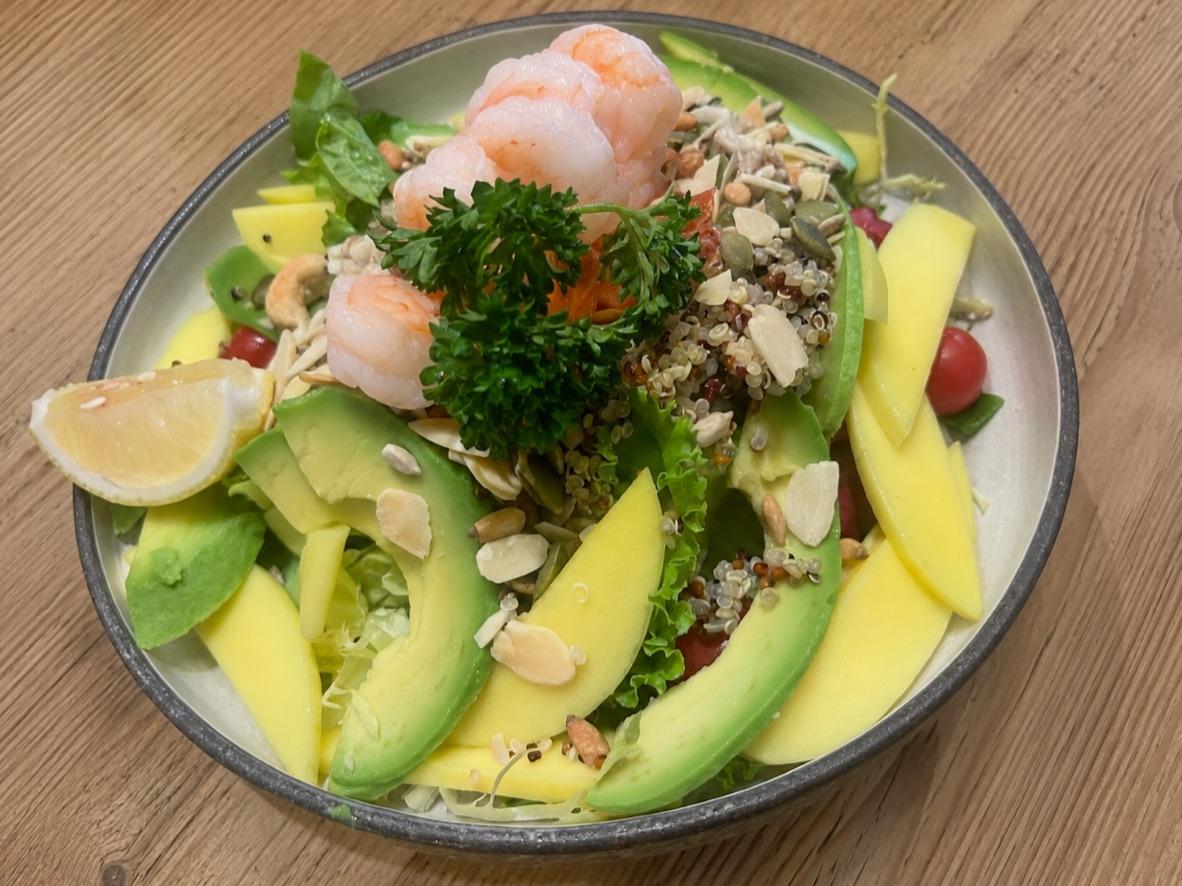Mango, avocado, and shrimp salad with quinoa, greens, almonds, and seeds