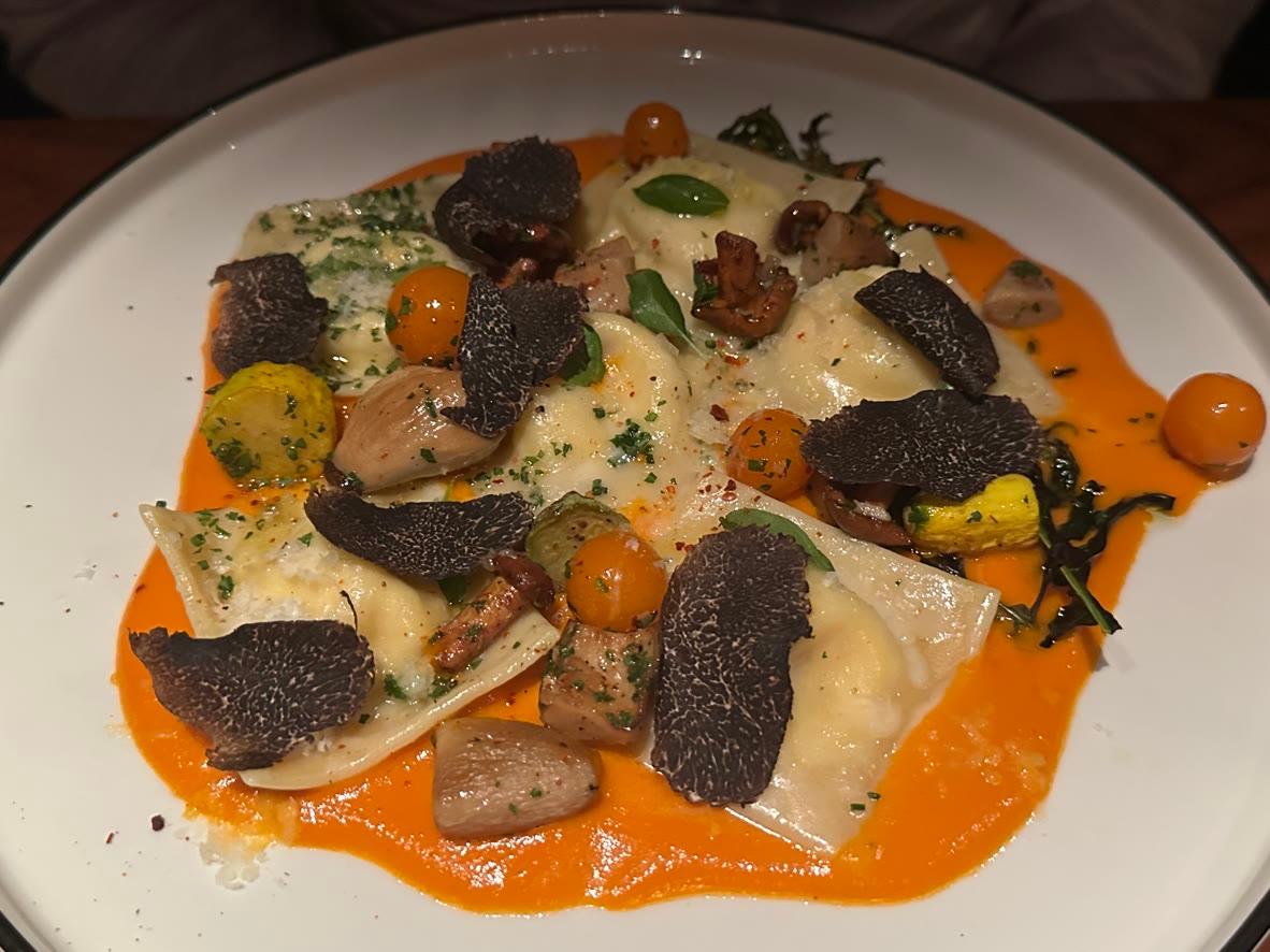 Ricotta ravioli with chanterelle mushrooms, tomato sauce, basil, and black truffle