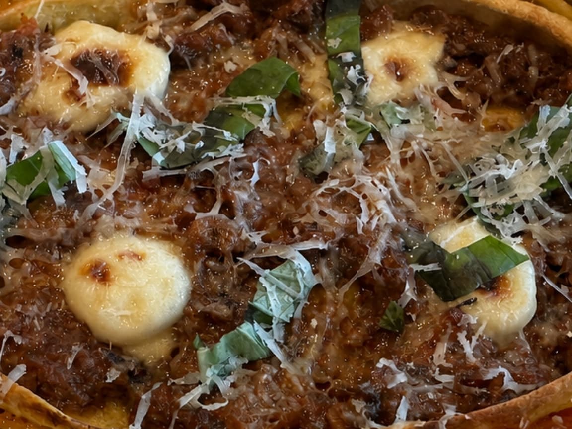 Braised short rib lasagna with Italian sausage ragù, ricotta, provolone, Parmesan, and fresh basil.