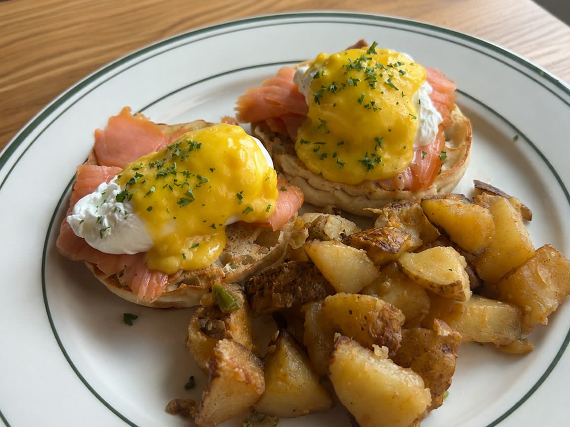 Smoked salmon eggs Benedict with poached eggs, hollandaise, and crispy home fries