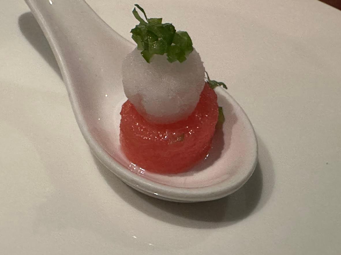 A chilled watermelon bite topped with cucumber-lime granita and fresh mint