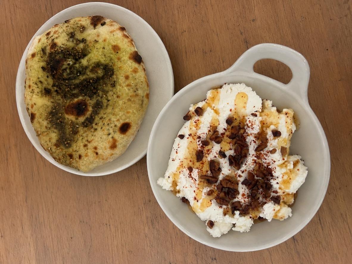 Whipped feta topped with honeyed walnuts beside za’atar naan