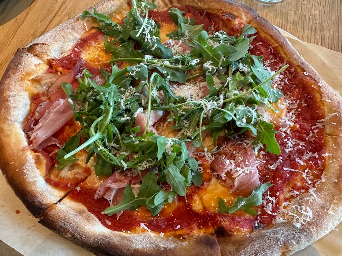 Hot honey prosciutto and arugula pizza