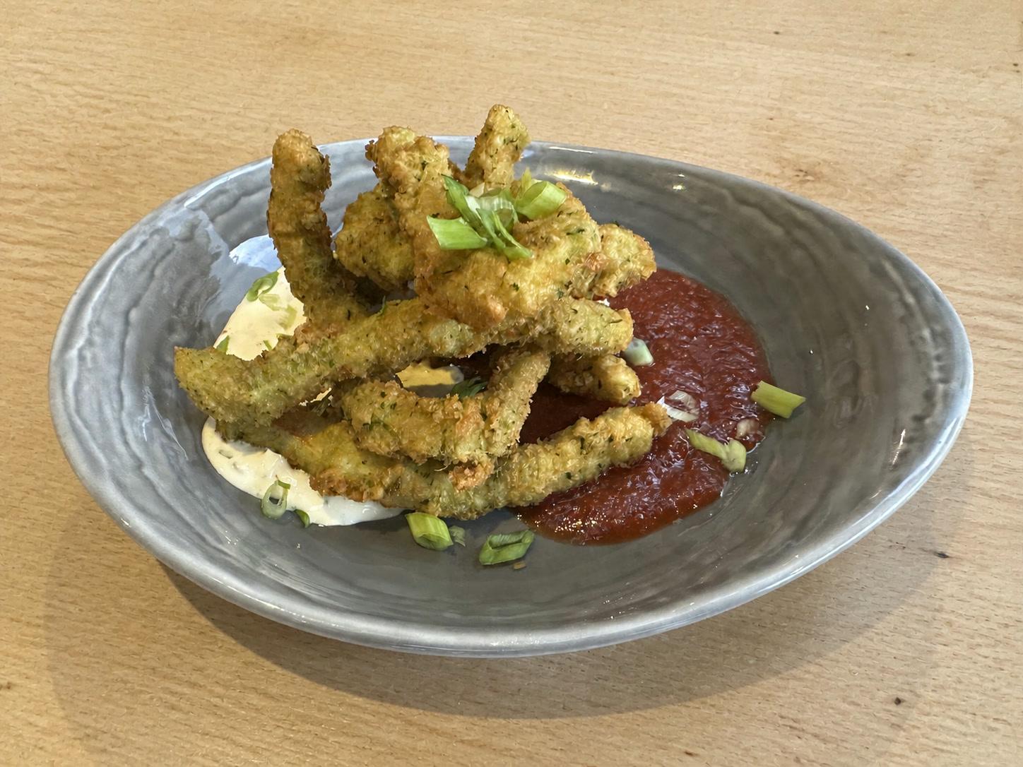 Crispy panko-crusted calamari with lemon remoulade, guava cocktail sauce, and sliced scallions