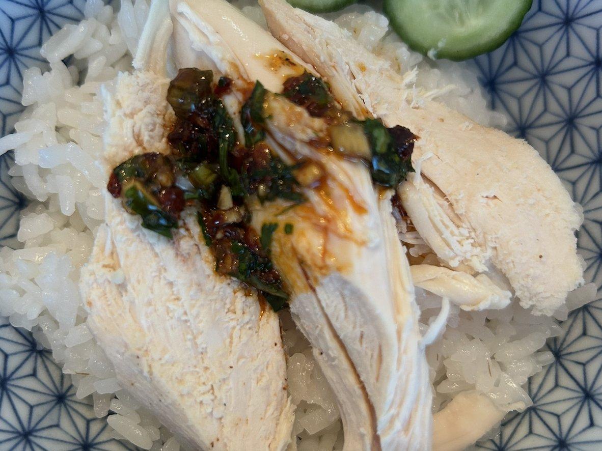 Rotisserie chicken rice bowl with cucumber and chili sauce